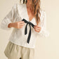 TEXTURED FABRIC WITH TIE IN THE FRONT BLOUSE